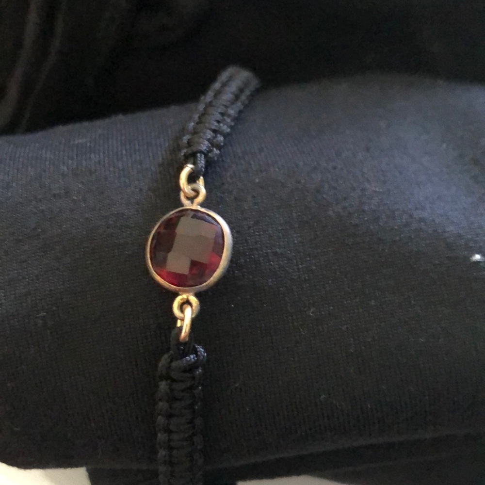 Macrame bracelet with red stone.